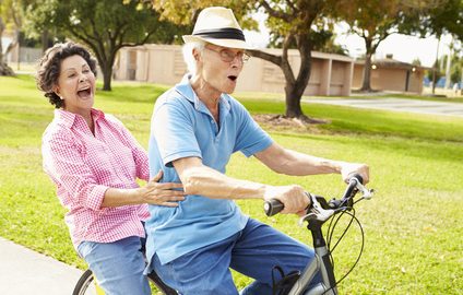 Couple on bike showing seniors focused oakville Physio clinic