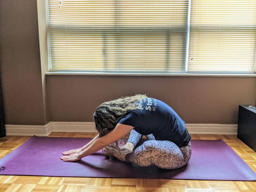 Oakville physio demonstrating a butterfly pose stretch in yin yoga for an educational blog